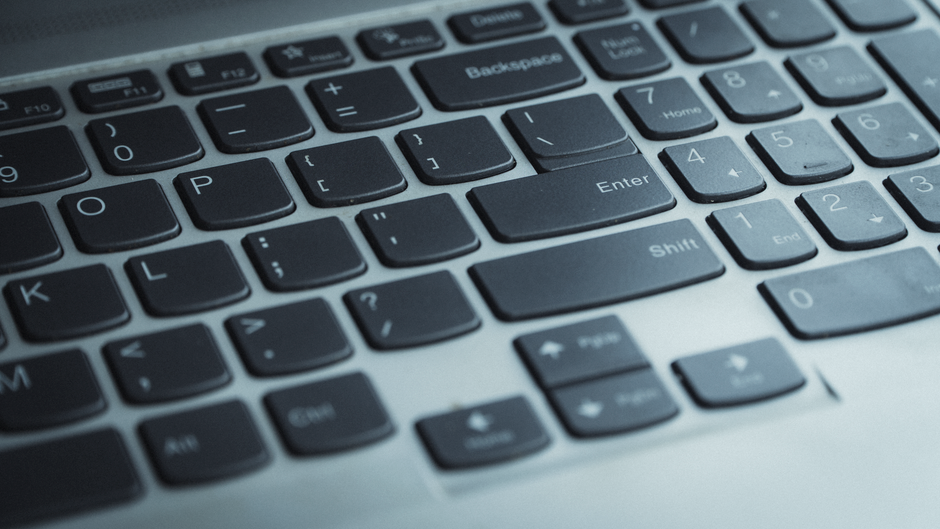 Detailed view of a laptop keyboard with focus on keys. Ideal for tech content.
