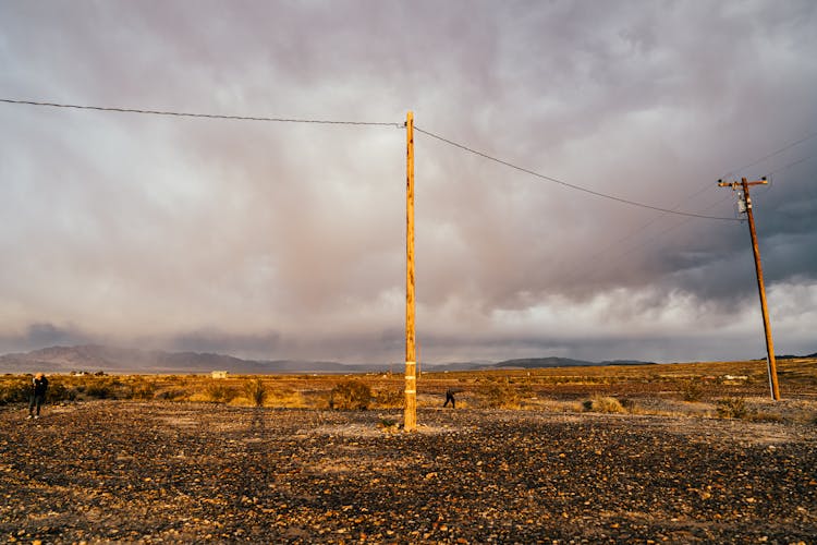 Utility Poles Near Empty Rural Terrain