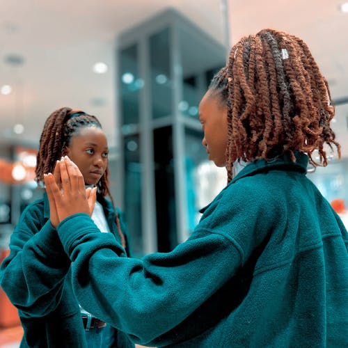 Woman Touching A Mirror