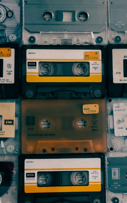 Free A collection of vintage audio cassette tapes with various labels, capturing the retro music era. Stock Photo