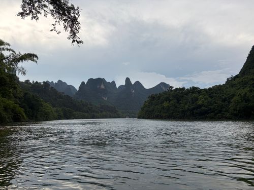 Free Scenic view of the tranquil river with karst mountains in Xianyang, Shaanxi, China under a cloudy sky. Stock Photo