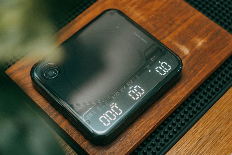 A close-up view of a digital kitchen scale on a wooden board, perfect for precise measurements.
