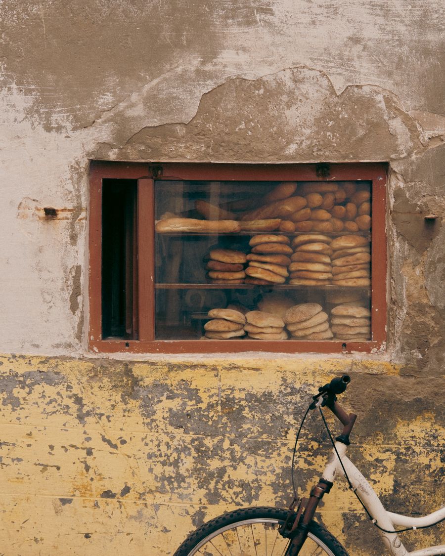 Loaves of bread in the window of a small bakery, photo by DIBLACL on Pexels