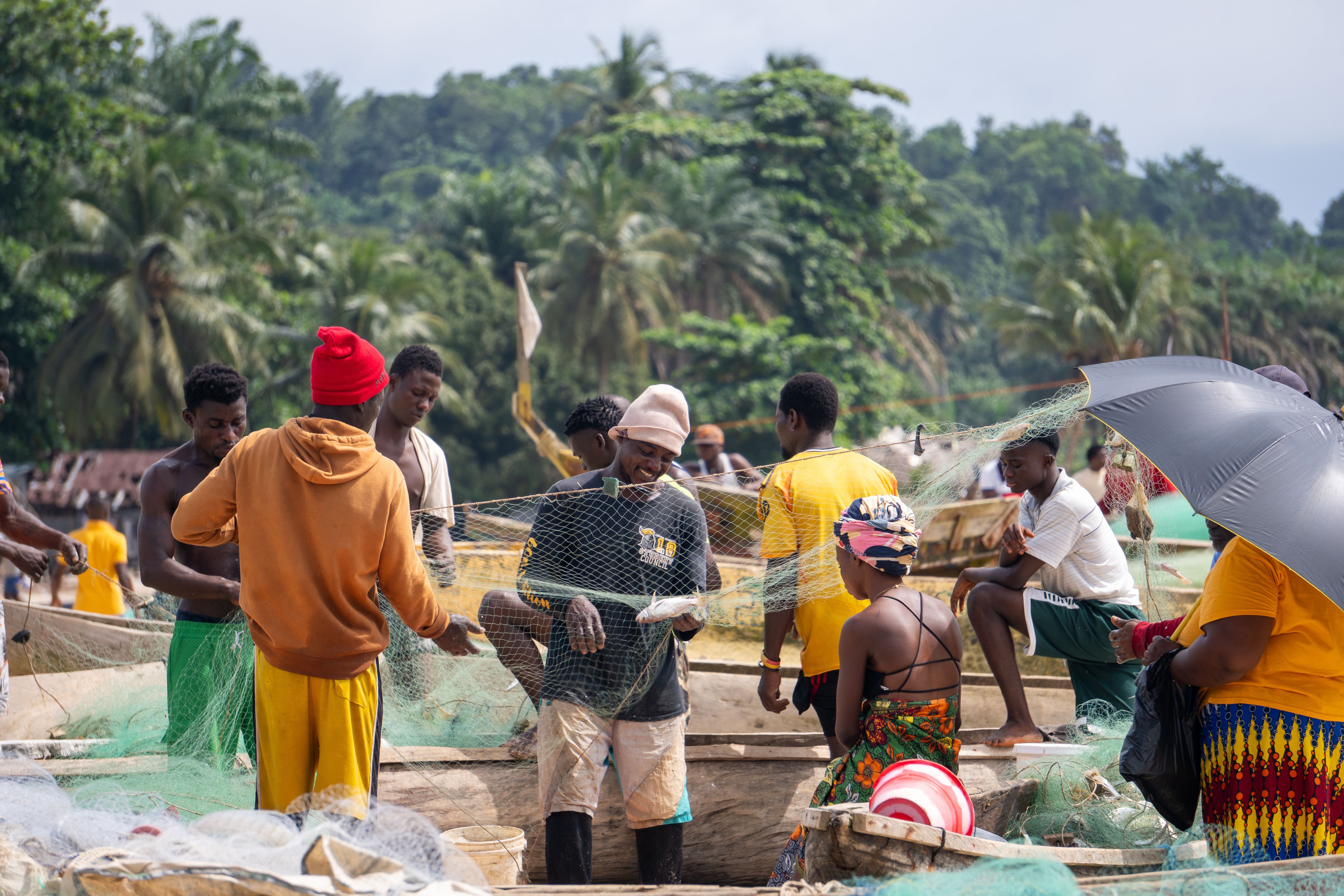 Community gathering at a village fishing port, Gabon