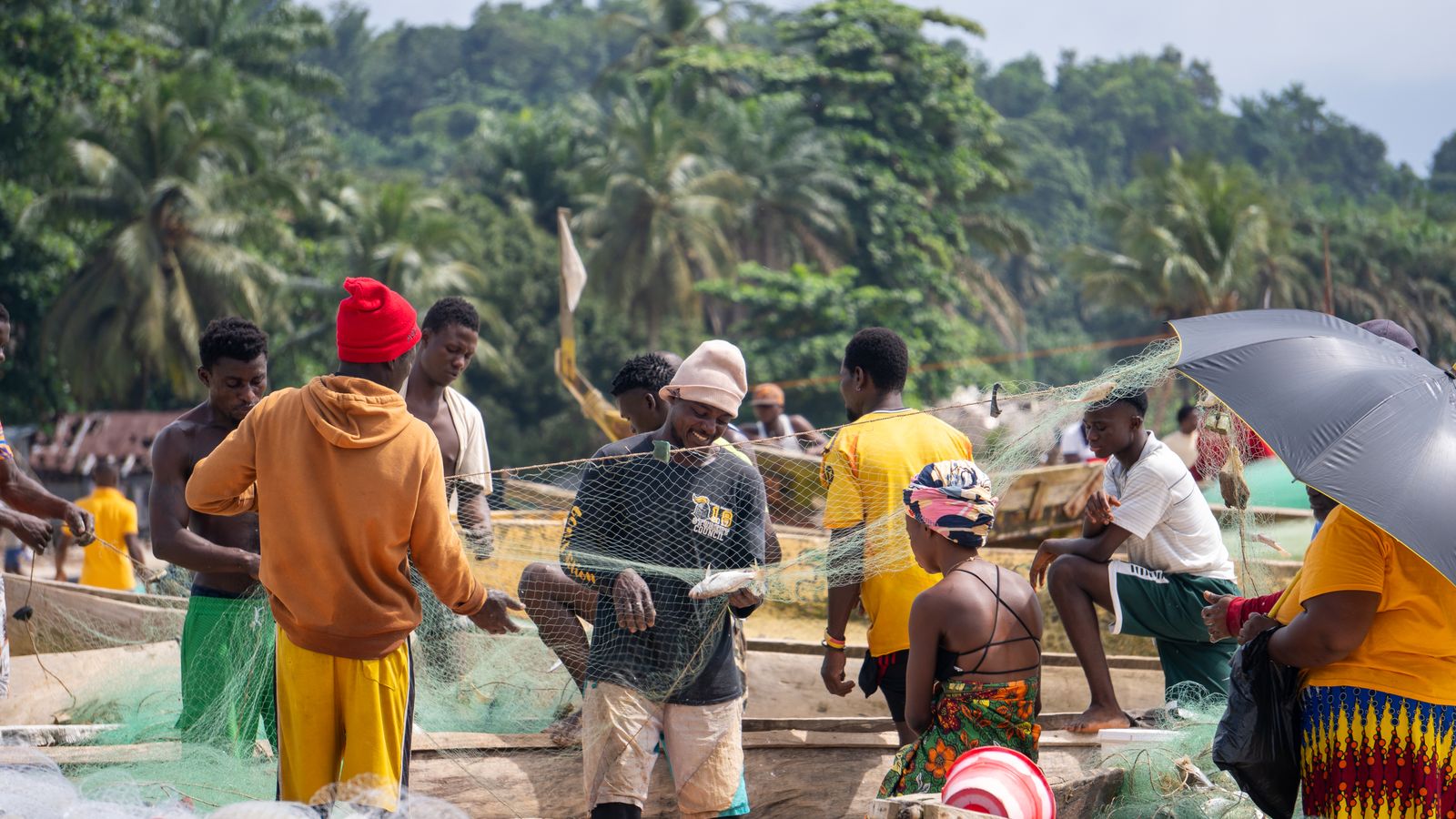 Community gathering at a village fishing port, Gabon