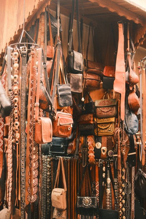 Free Explore a vibrant display of handmade leather bags and belts in Fes market, Morocco. Stock Photo