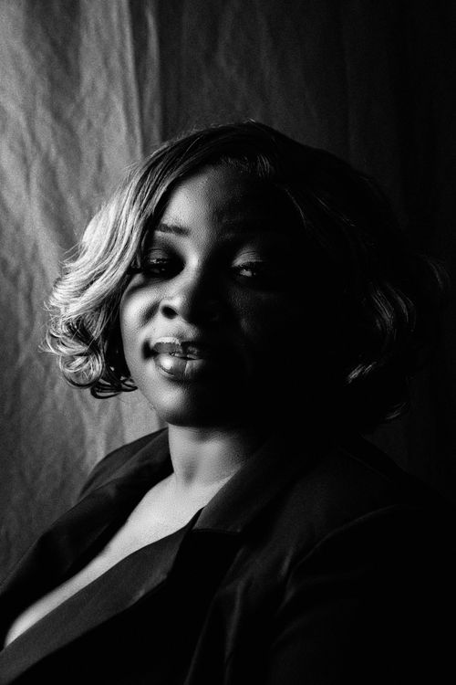 Free Black and white portrait of a woman with short hair and elegant attire, conveying dramatic mood. Stock Photo