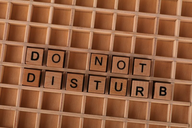 Wooden blocks spelling 'Do Not Disturb' arranged in a grid pattern.
