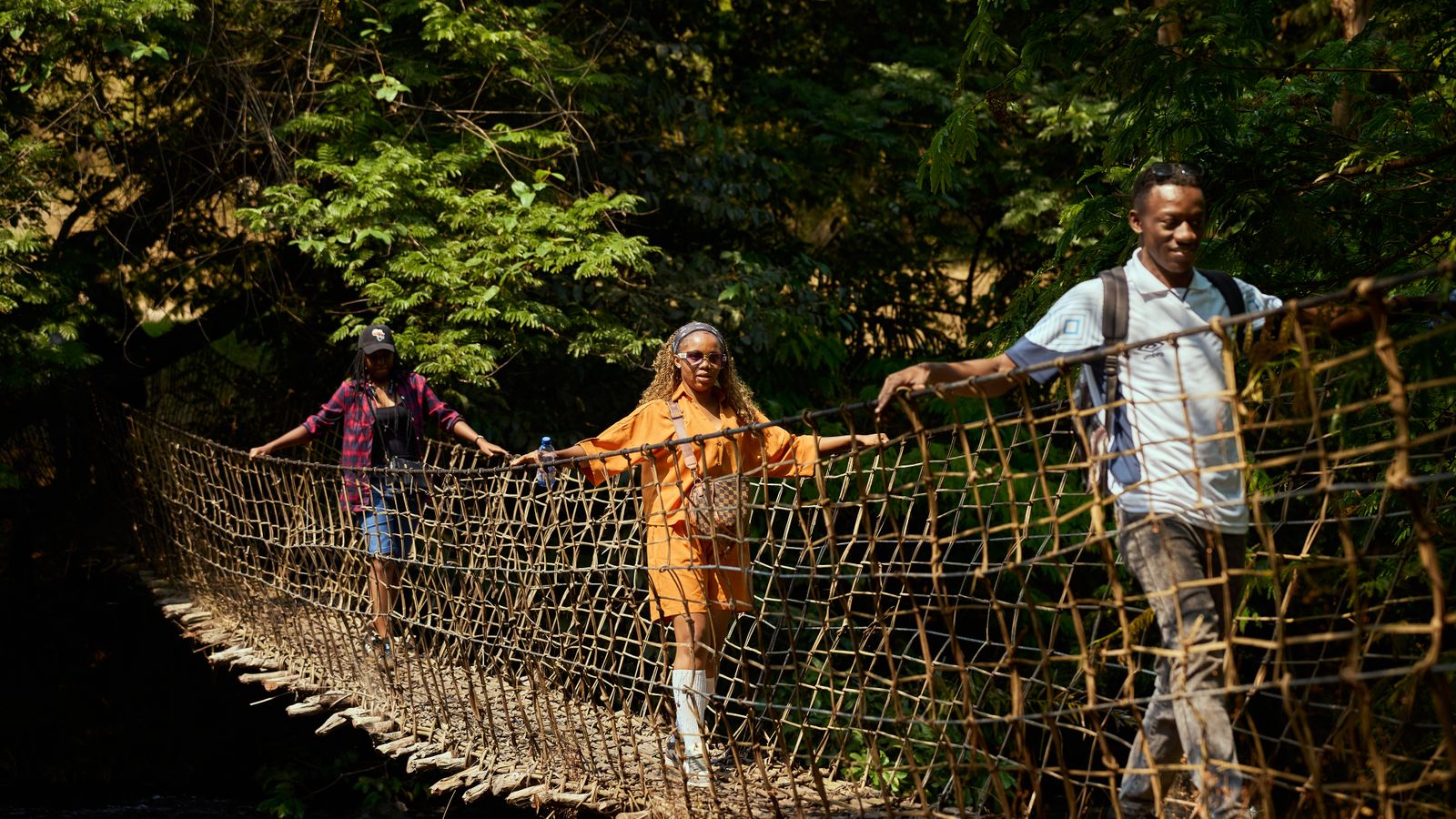 Adventurous walk on a rope bridge in the forest, Sierra Leone