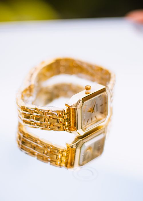 Free Close-up of a luxurious gold watch with a reflective surface, highlighting elegance and craftsmanship. Stock Photo