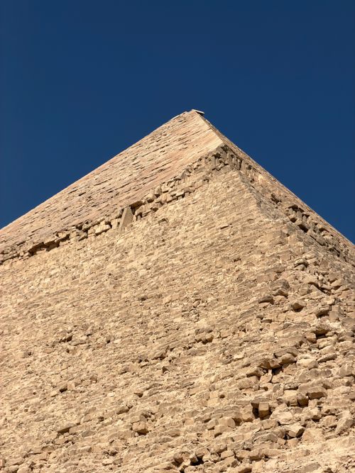 Free Close-up of the Pyramid of Giza showcasing limestone texture under a clear blue sky. Stock Photo