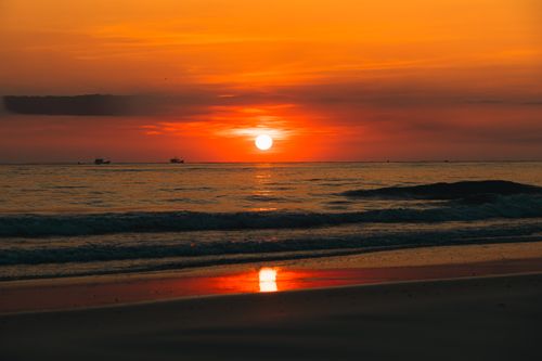 Free Dramatic sunset view on the beach of Quảng Trị, Vietnam, with vivid colors reflecting on the ocean. Stock Photo