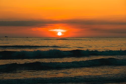Free Serene sunset over the ocean in Quảng Trị, Vietnam, displaying vibrant orange hues. Stock Photo