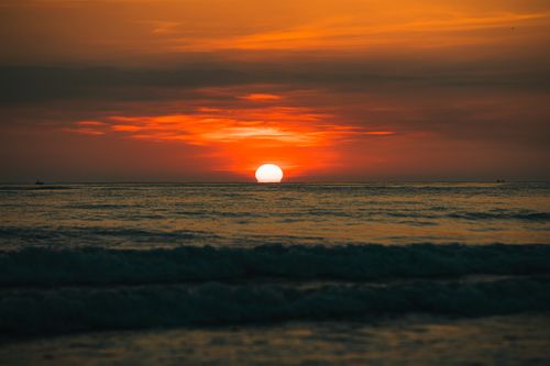 Free A breathtaking sunset over the ocean in Quảng Trị, Vietnam, with vibrant orange hues reflecting on tranquil waters. Stock Photo