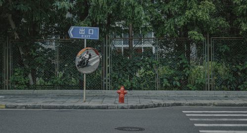 Free Street scene showing an exit sign, reflective traffic mirror, and red hydrant. Stock Photo