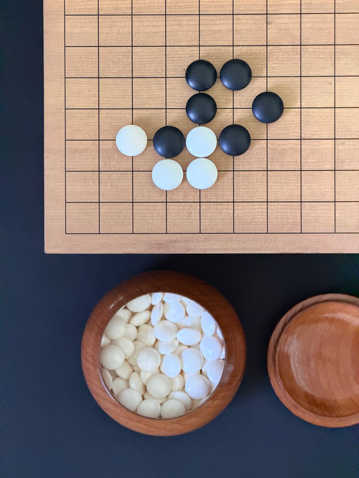 Overhead view of a go board with black and white stones