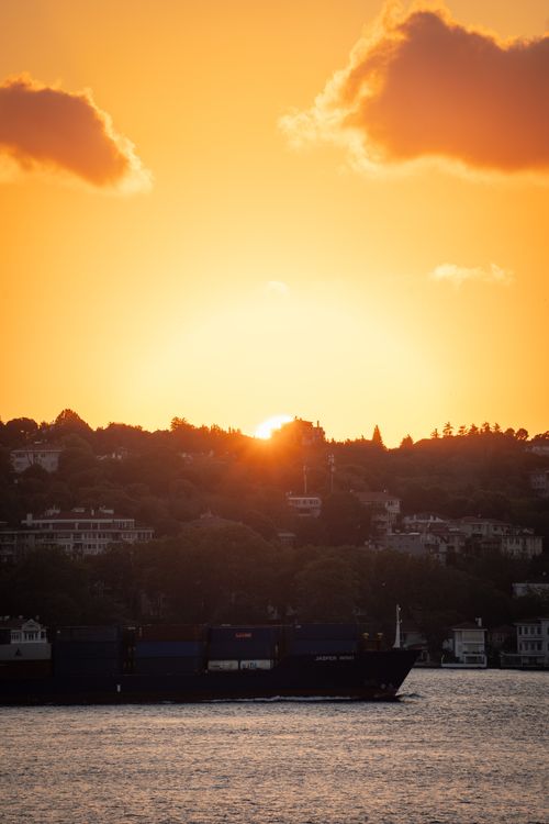 Free Dramatic sunset over Istanbul with a silhouette of a cargo ship in the foreground. Stock Photo
