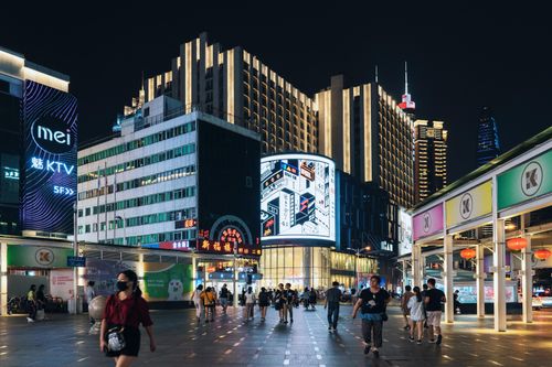 Free Vibrant urban scene with illuminated skyscrapers and people at night. Stock Photo