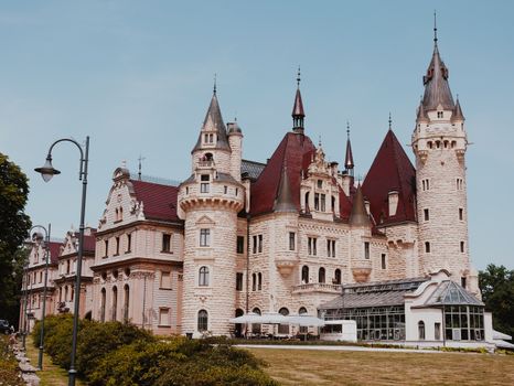 Captivating exterior of Moszna Castle in Opole, Poland, on a sunny day.