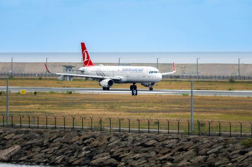 Free Turkish Airlines aircraft on runway at Rize Airport, Türkiye with sea backdrop. Stock Photo