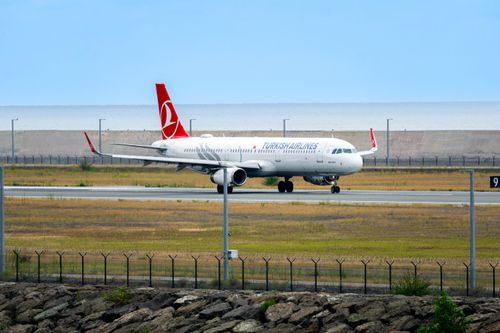 Free A Turkish Airlines aircraft prepares for takeoff on a runway surrounded by scenic views in Rize, Türkiye. Stock Photo