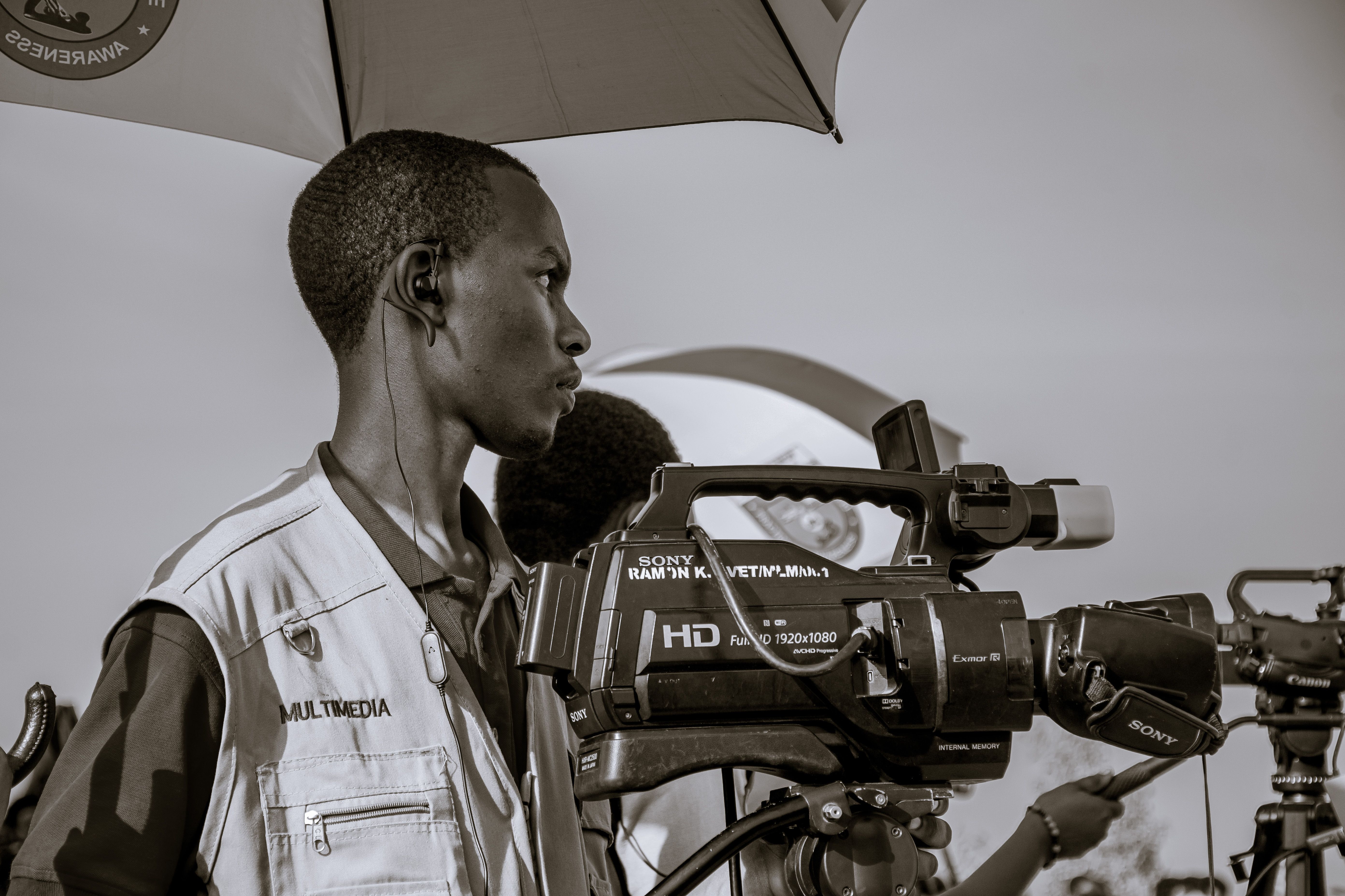 Videographer using professional equipment at an event in Ruhango, Rwanda.