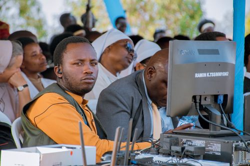 Free A group scene showing people at an outdoor event using computers in Ruhango, Rwanda. Stock Photo