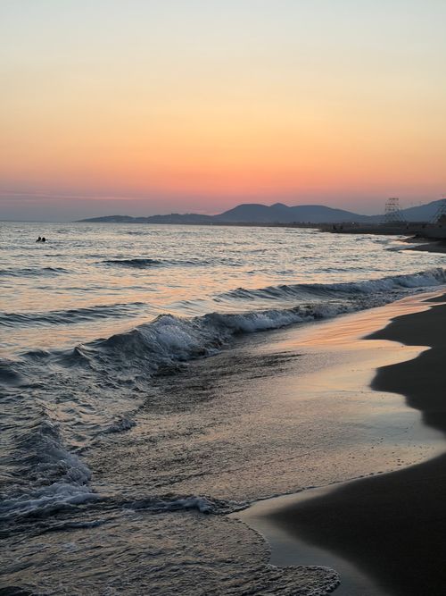 Free Beautiful sunset over the beach in Montenegro, capturing gentle waves and a calm evening sky. Stock Photo