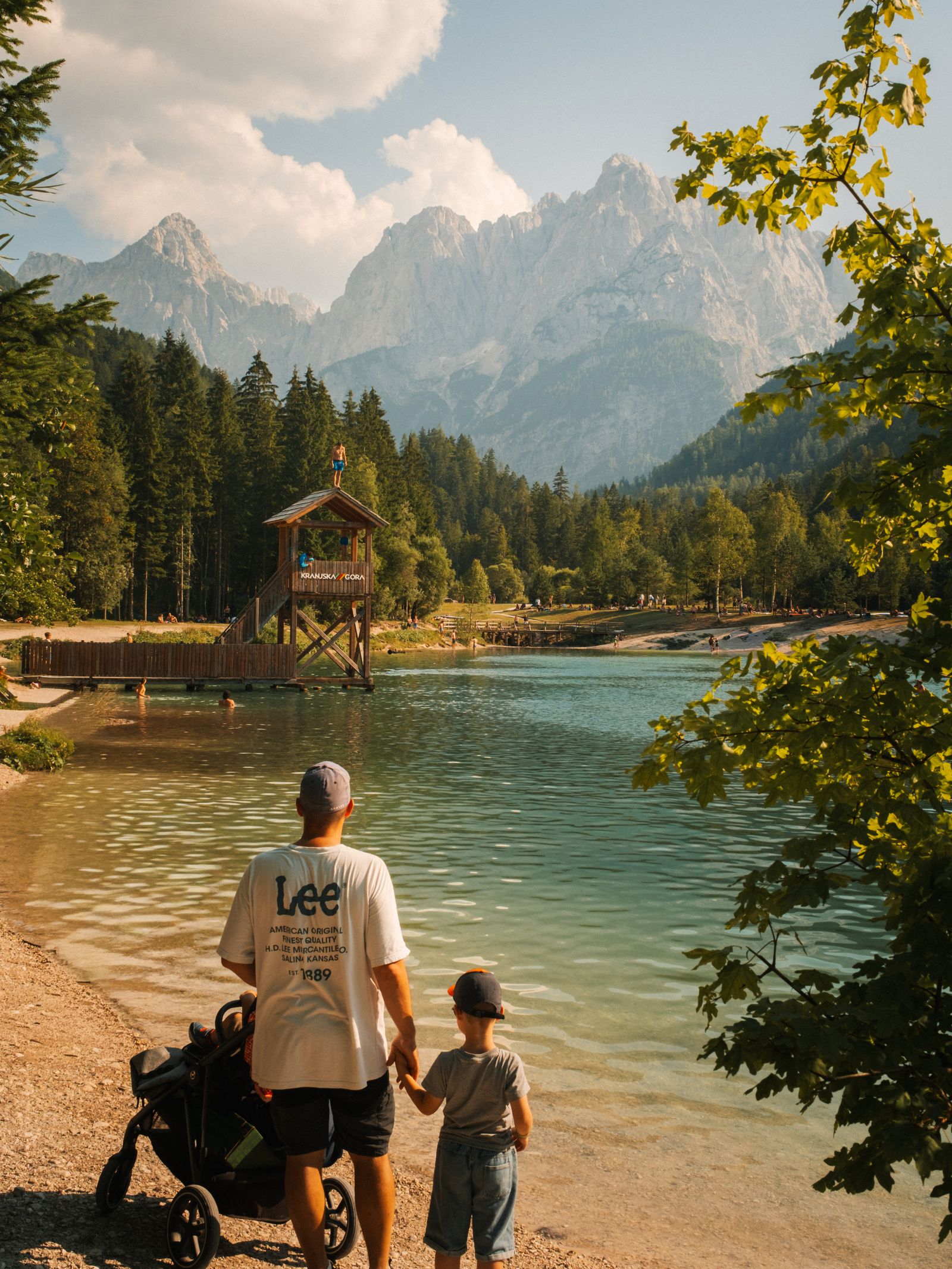 Parent and child enjoying an alpine lake view in Kranjska Gora