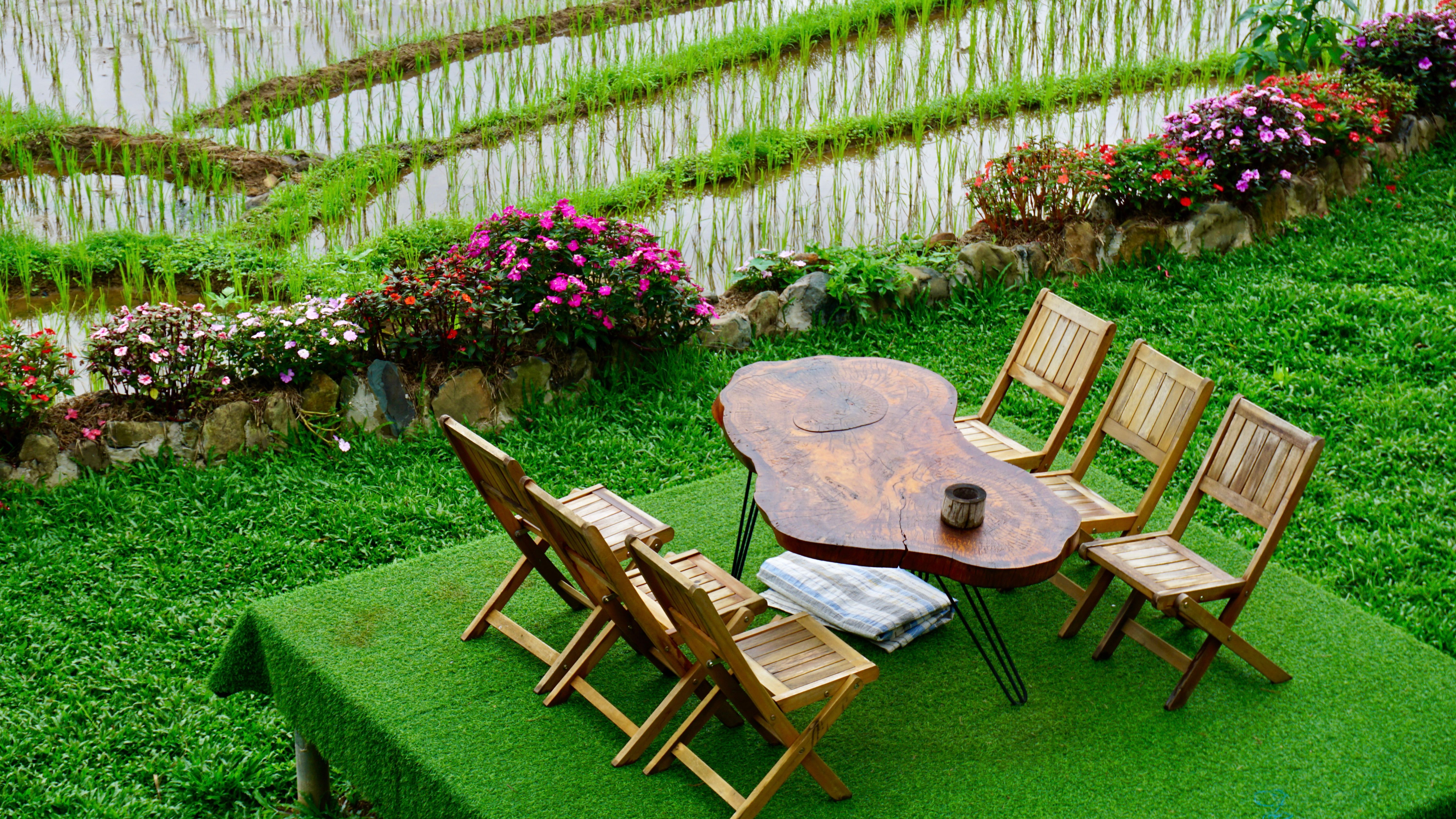 A serene outdoor cafe setup overlooking vibrant rice terraces in Pu Luong, Vietnam.
