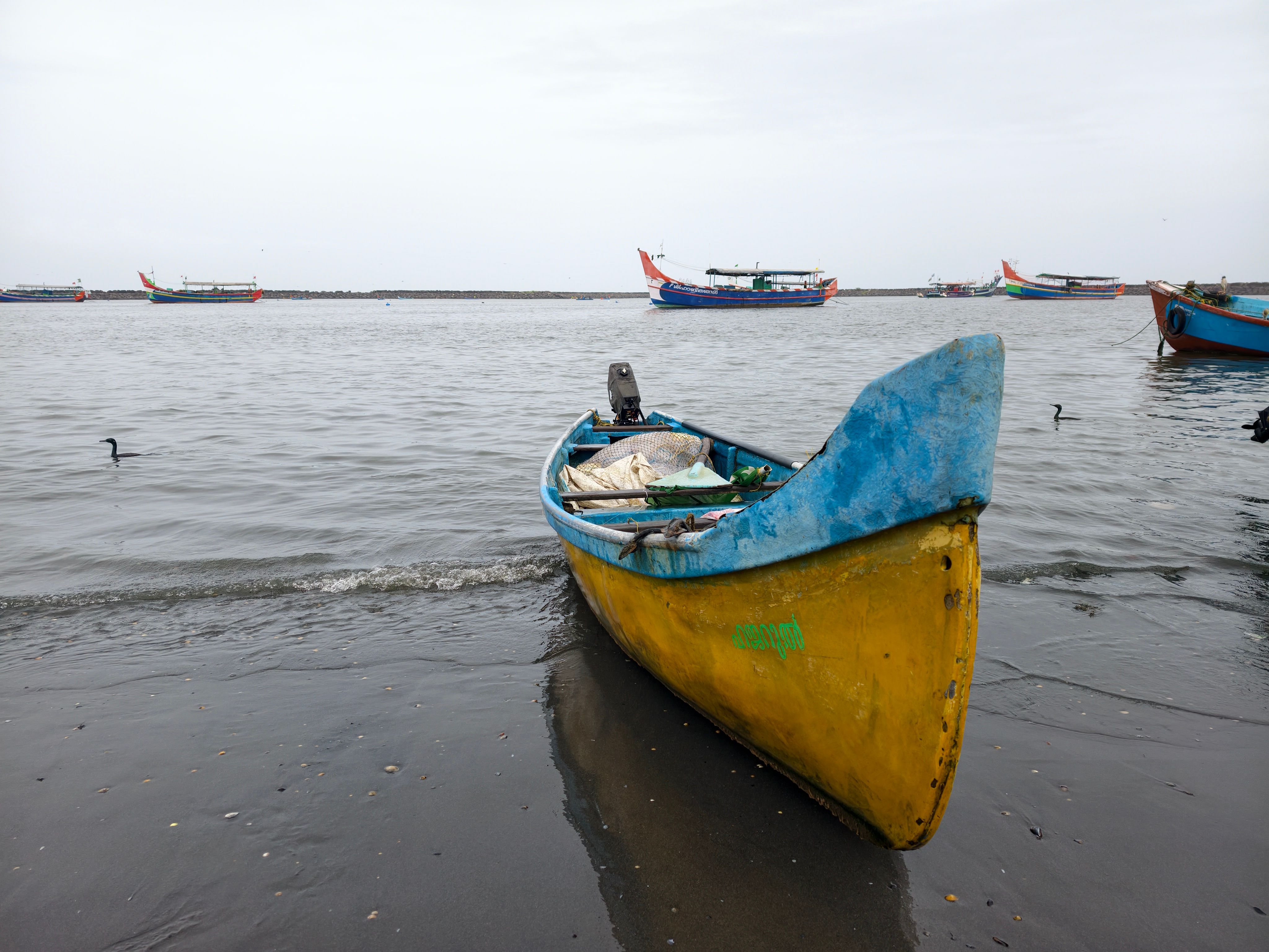 Fishing boats at the Periyar river mouth beside Munambam Beach at the tip of Vypin