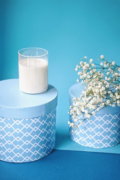 White and Black Blue Round Box on the Table