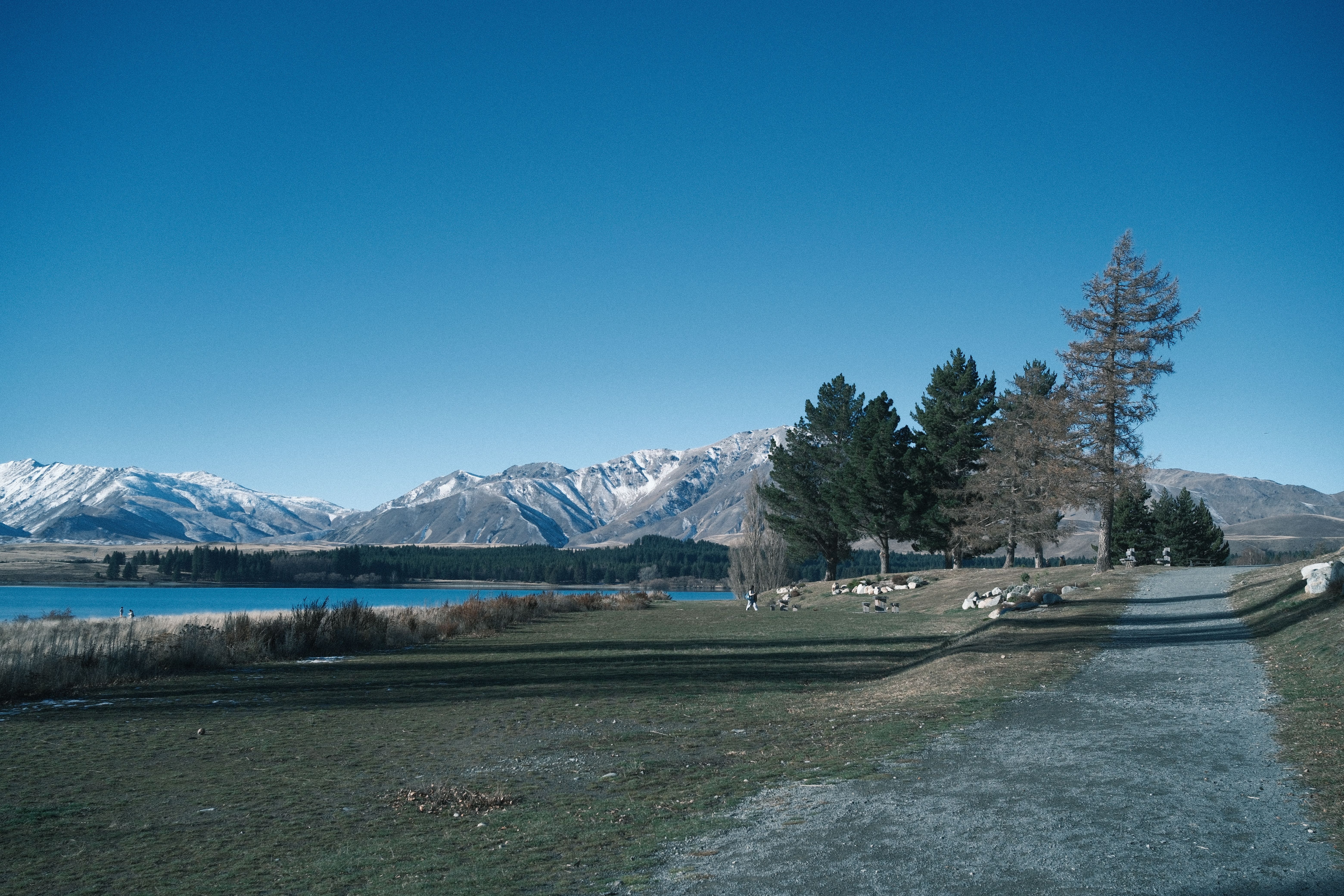 Lake Tekapo with snow on the mountains behind it