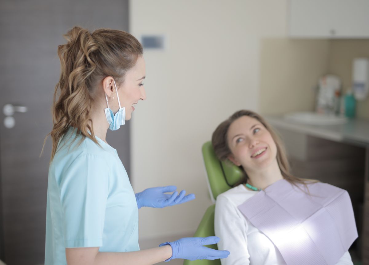 Dr. Wadie talks with a patient before treatment at Dental Spot