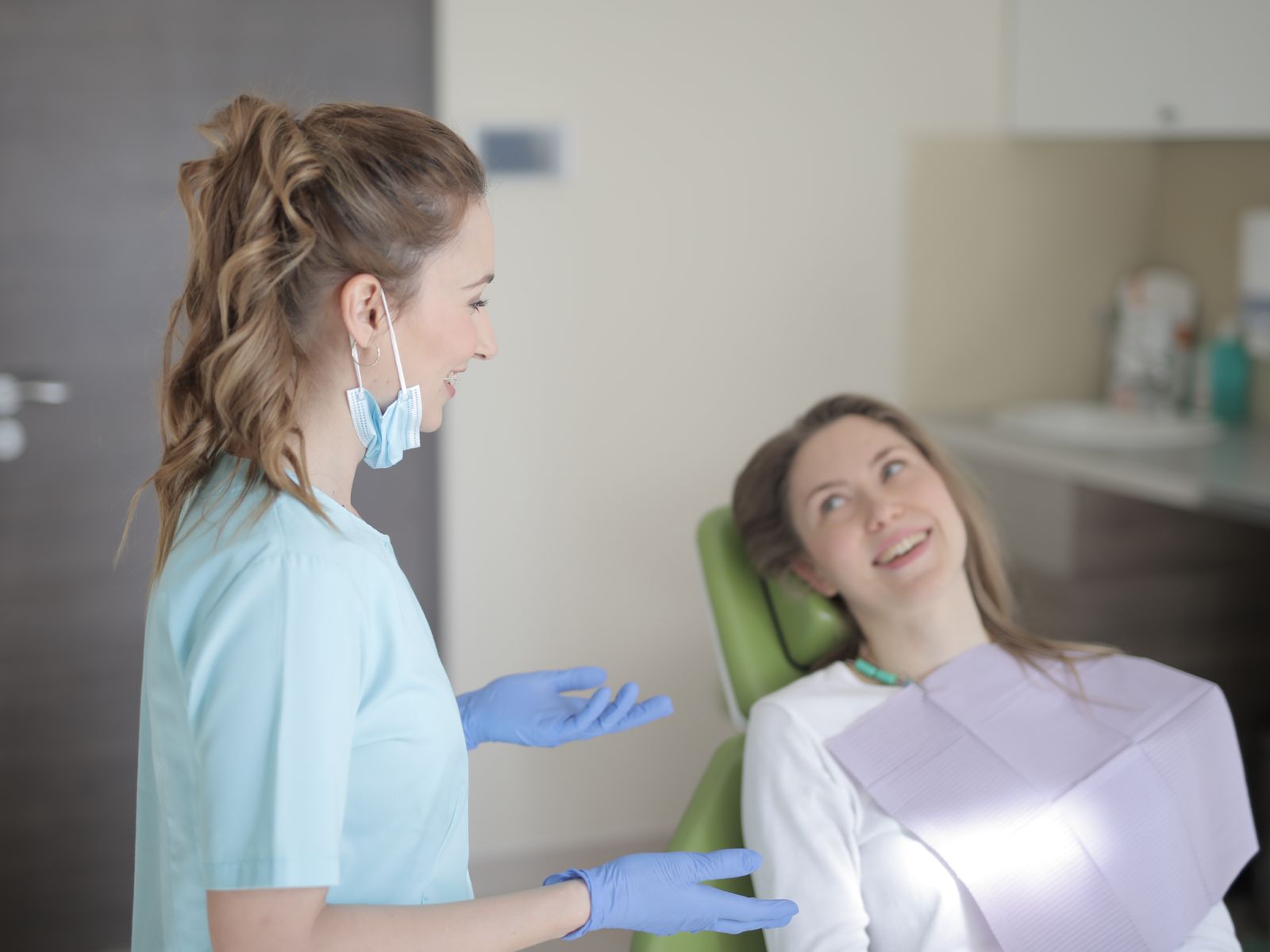 Smiling dentist speaking with a patient during a consultation