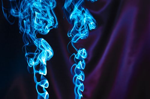 Free Artistic capture of swirling blue smoke against a dark backdrop, creating a mystical and vibrant effect. Stock Photo
