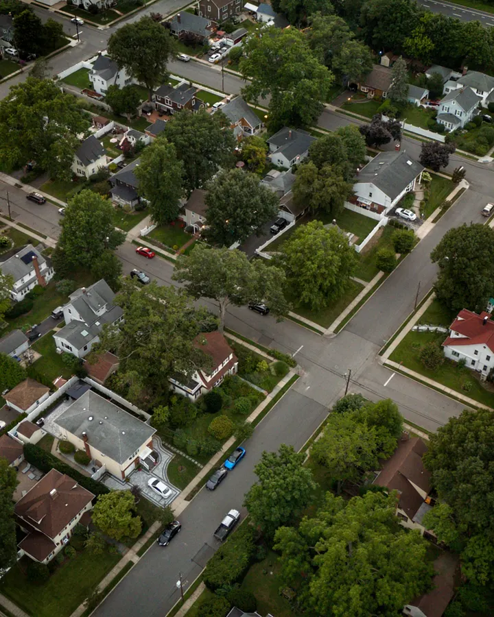 Refrigerator repair in San Carlos, CA Aerial view of a suburb with houses and lush green trees in summer, like the San Carlos neighborhood