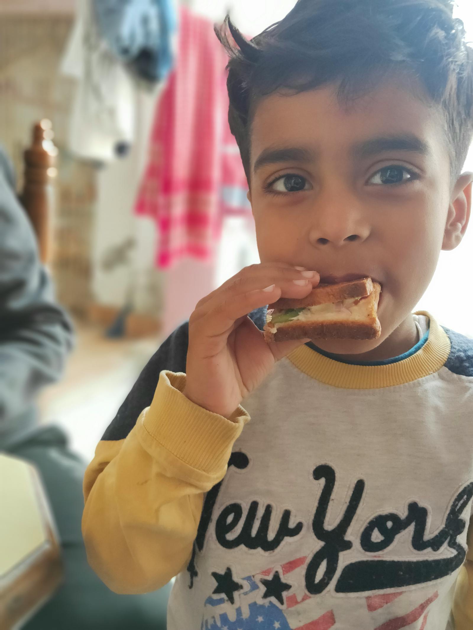 Person holding a smartphone scrolling through social media in the dark