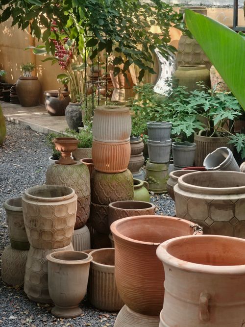 Free A diverse collection of clay pots displayed outdoors, surrounded by greenery. Stock Photo