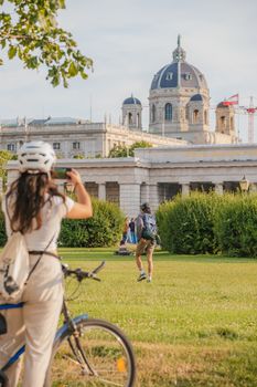 Tourists capture scenic views of Museum of Natural History in Vienna, Austria.