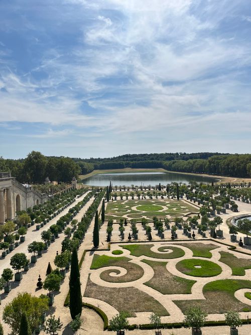 Free Stunning aerial view of Versailles' ornate gardens under a clear blue sky in summer. Stock Photo