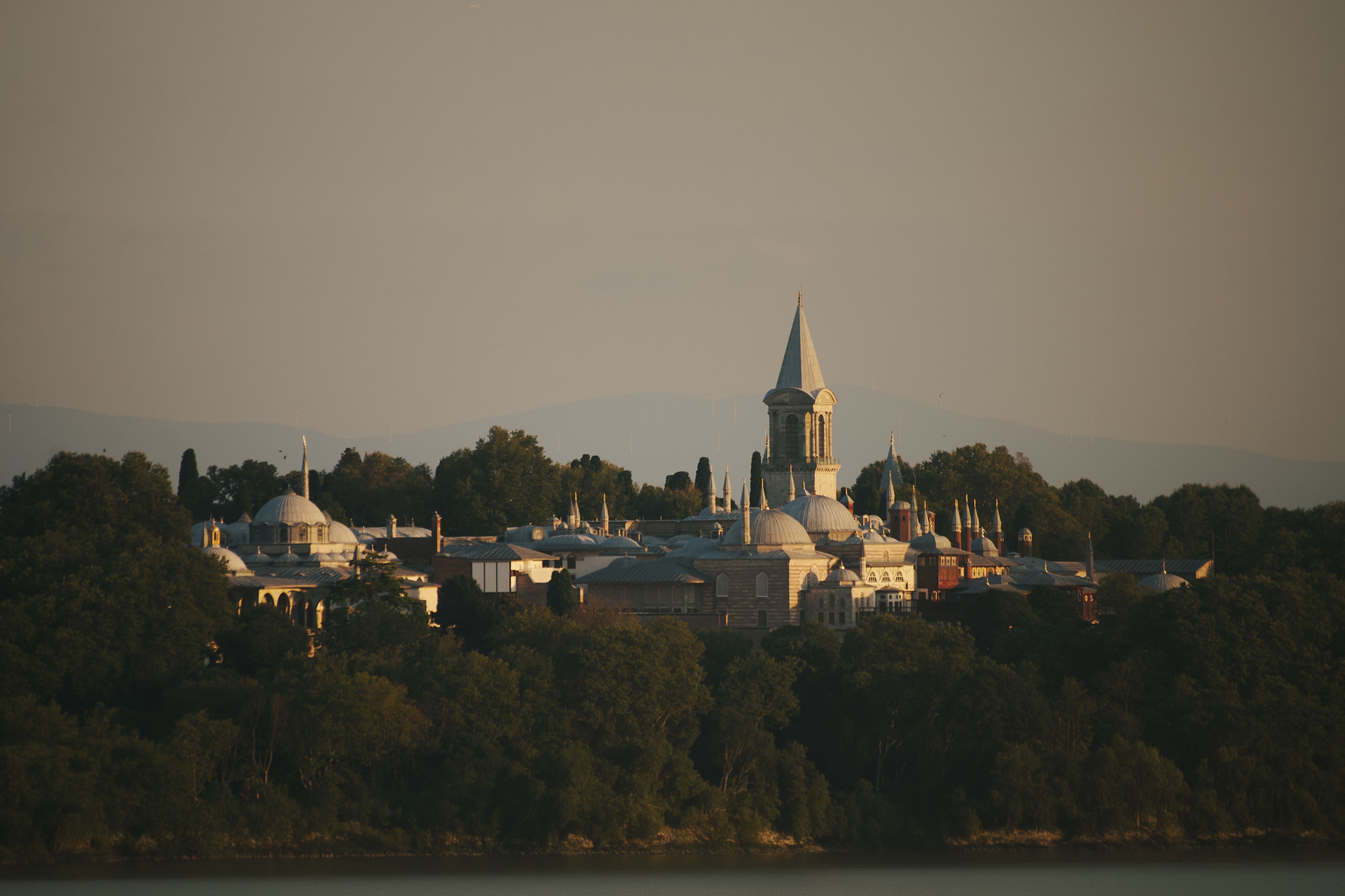 Scenic view of Topkapi Palace bathed in golden sunset light in Istanbul, Turkey.