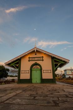 Vintage train station in Santa Luzia, Brazil, captured at dusk under a clear sky.