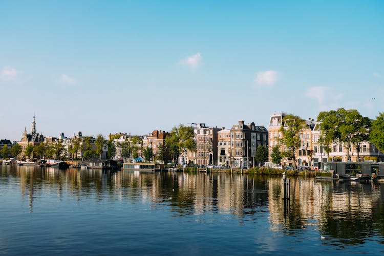 Old City District On River Bank On Sunny Day