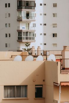 Explore the geometric facades and warm light on a sunny day in Los Cristianos, Spain.
