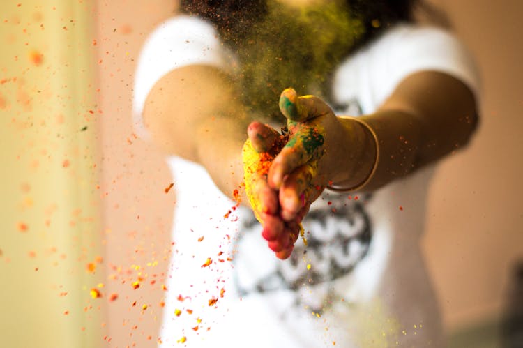 Person With Colored Powder On Her Hands