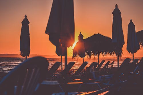 Silhouette Photo of Patios on Beach Shore