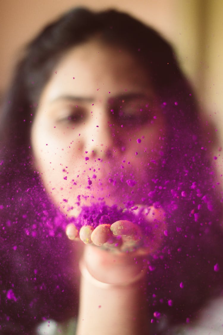 Woman With Purple Powder On Her Hand