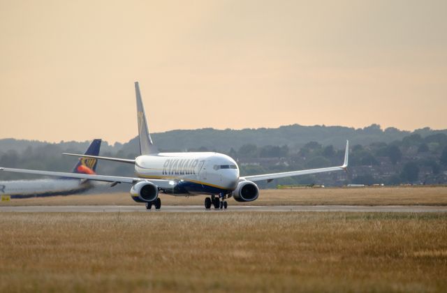 A Ryanair Boeing 737 taxiing on runway during golden hour at Luton Airport. — arriving in London