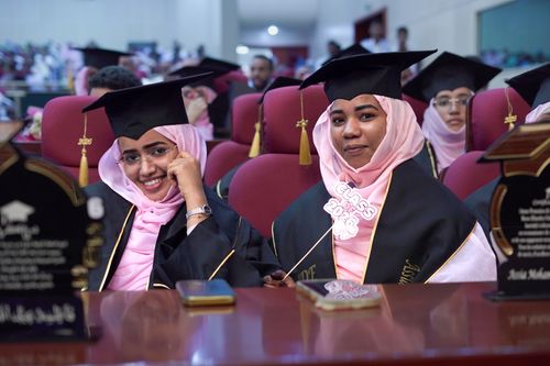 Free Happy graduates in caps and gowns at a ceremony, celebrating Class of 2023. Stock Photo